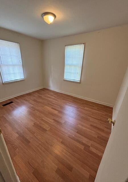 empty room with hardwood / wood-style floors