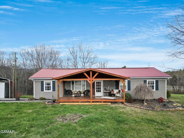 ranch-style house with a deck and a front lawn