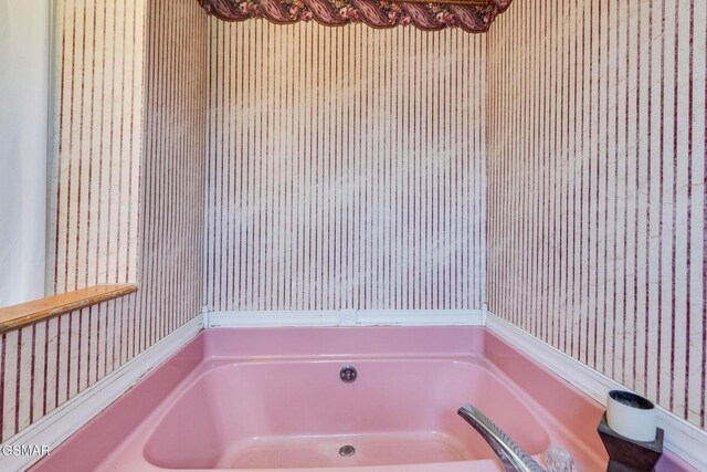 bathroom featuring a tub to relax in