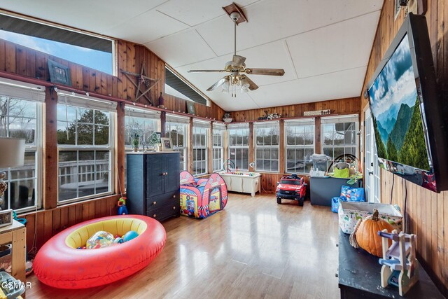 sunroom / solarium with ceiling fan and vaulted ceiling