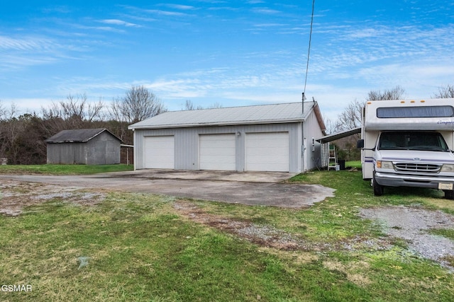 garage featuring a lawn