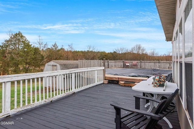 wooden terrace featuring a storage unit