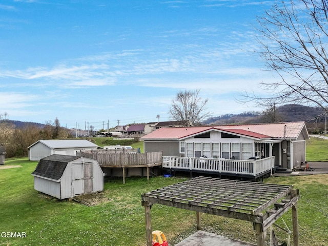 view of yard with a wooden deck and a storage unit