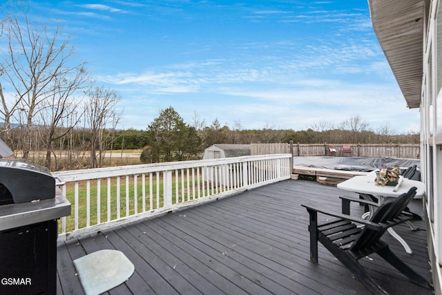 wooden terrace with a grill