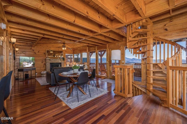 2412 Breezey Ridge Dr, Sevierville, TN 37876 - dining space with wood walls, a wood ceiling with exposed beams, a fireplace, hardwood / wood-style flooring, and ceiling fan