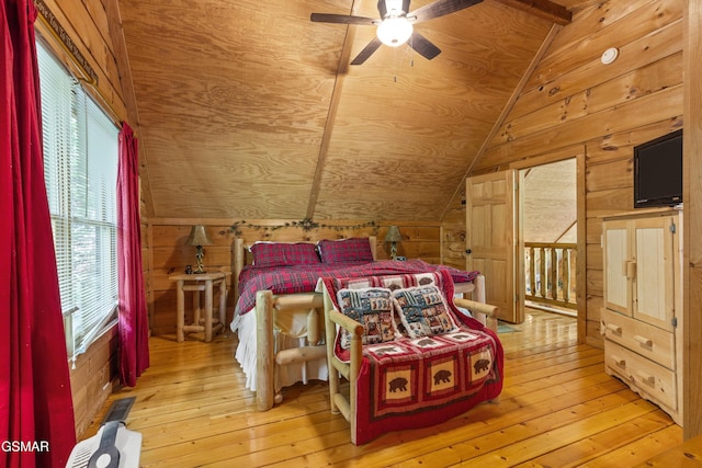 bedroom featuring wooden walls, light wood-style flooring, multiple windows, ceiling fan, and wooden ceiling
