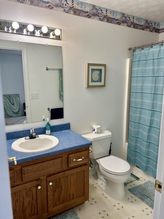 full bathroom with shower / bath combo, vanity, a textured ceiling, and toilet