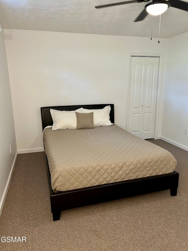 bedroom featuring carpet flooring, baseboards, a closet, and a ceiling fan