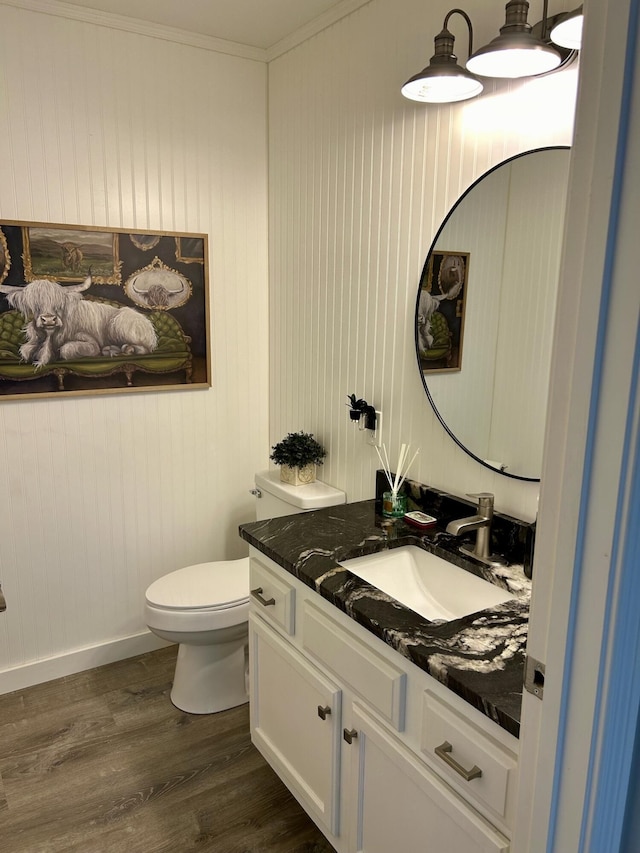 bathroom featuring crown molding, toilet, vanity, and hardwood / wood-style flooring