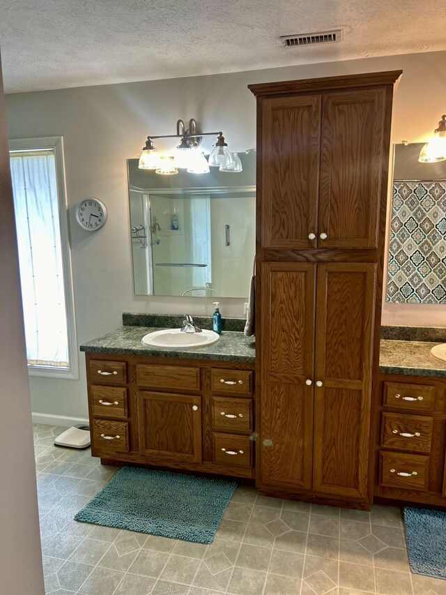 bathroom featuring vanity and a textured ceiling