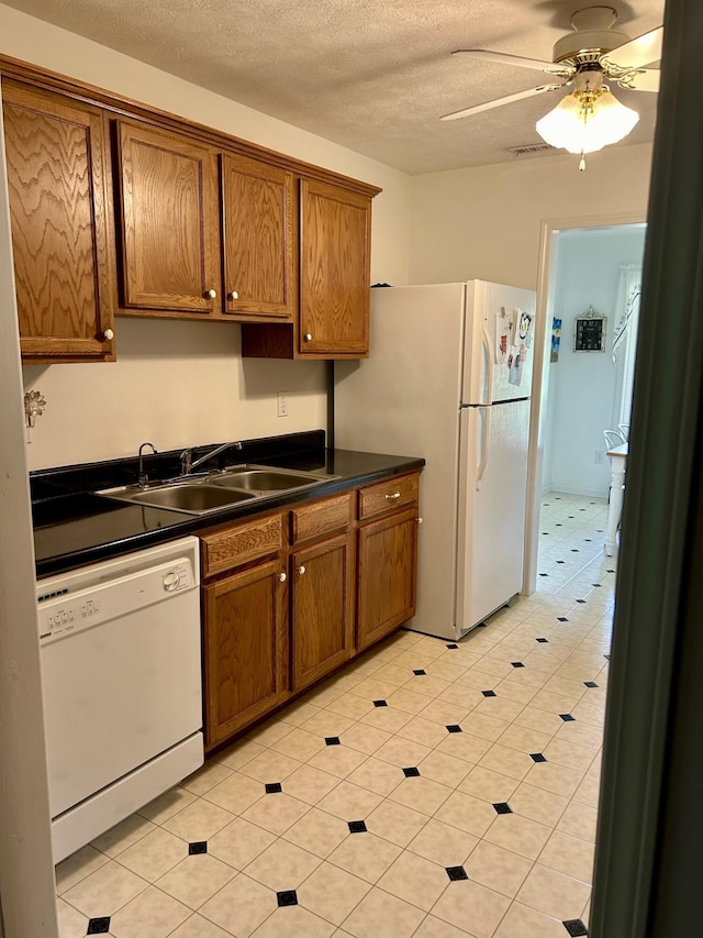 kitchen featuring ceiling fan, sink, a textured ceiling, white appliances, and light tile patterned flooring