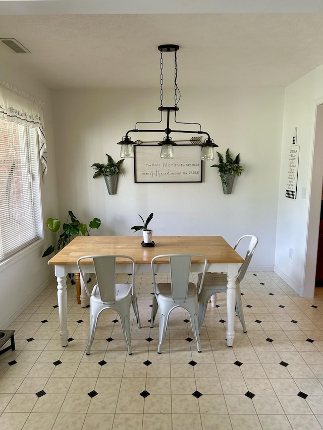 dining area featuring light tile patterned floors