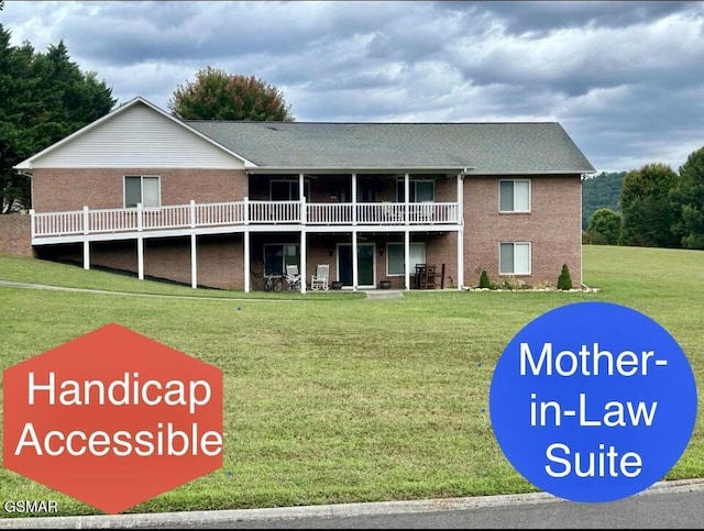 back of house featuring a lawn and a deck