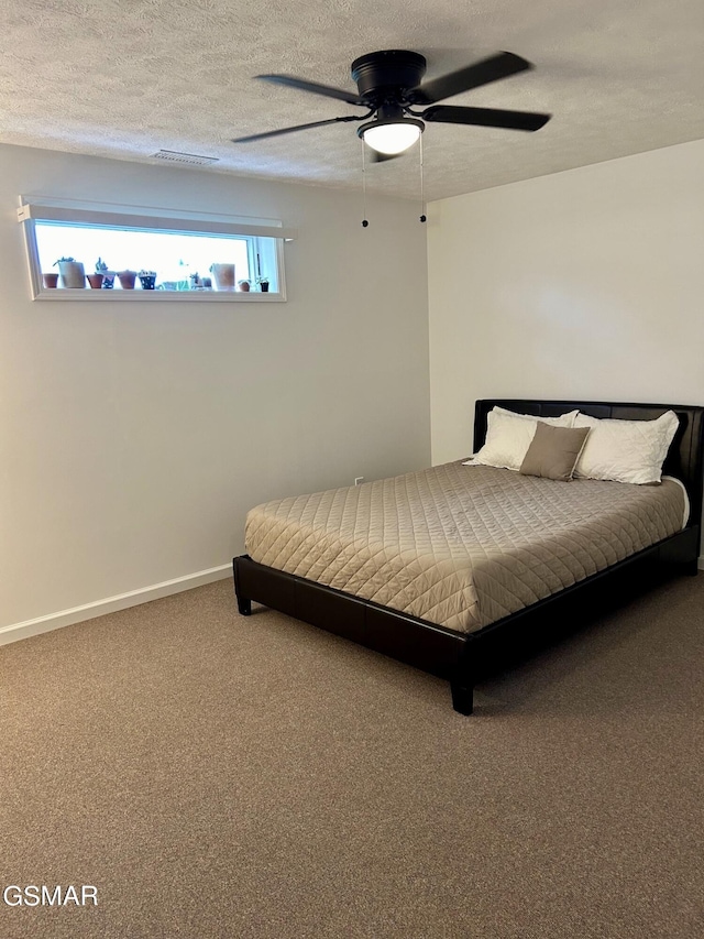 unfurnished bedroom featuring carpet, ceiling fan, and a textured ceiling