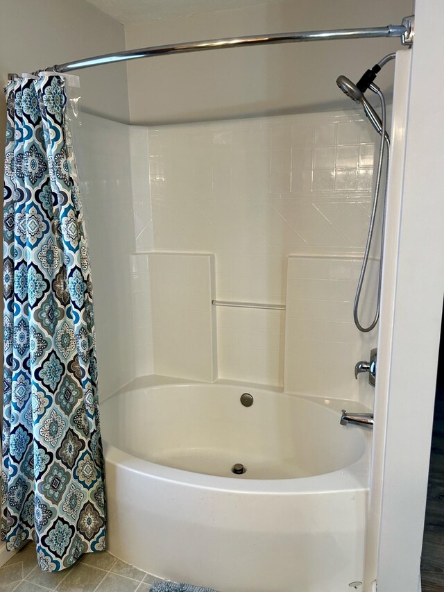 bathroom with tile patterned floors and shower / bathtub combination with curtain