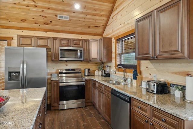 3316 Grace Way, Sevierville, TN 37876 - kitchen with stainless steel appliances, a sink, lofted ceiling, light stone counters, and wooden ceiling