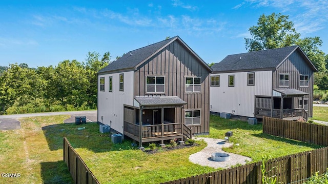1105 Center St # 3, Sevierville, TN 37862 - back of house with board and batten siding, a fenced backyard, a shingled roof, and a deck
