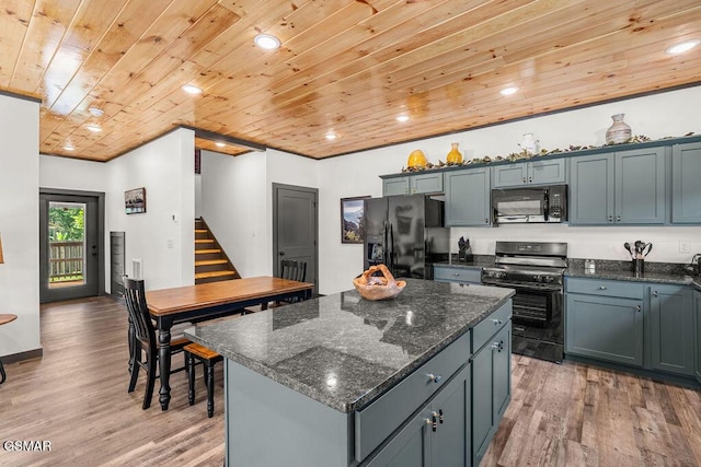 1105 Center St # 3, Sevierville, TN 37862 - kitchen featuring black appliances, wooden ceiling, light wood-type flooring, a kitchen island, and dark stone counters