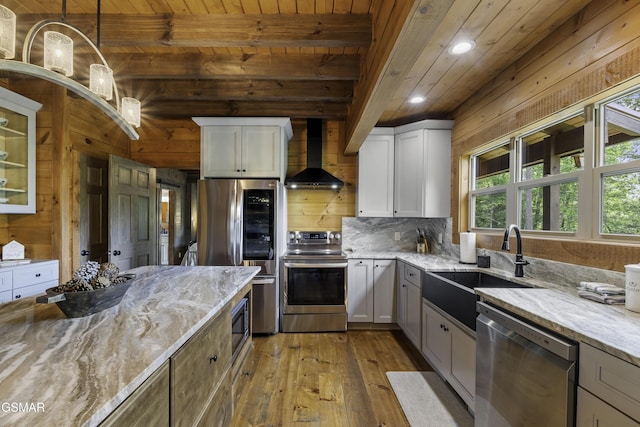 4427 Stackstone Rd, Sevierville, TN 37862 - kitchen with stainless steel appliances, wall chimney range hood, wood ceiling with exposed beams, wood-type flooring, and light stone countertops