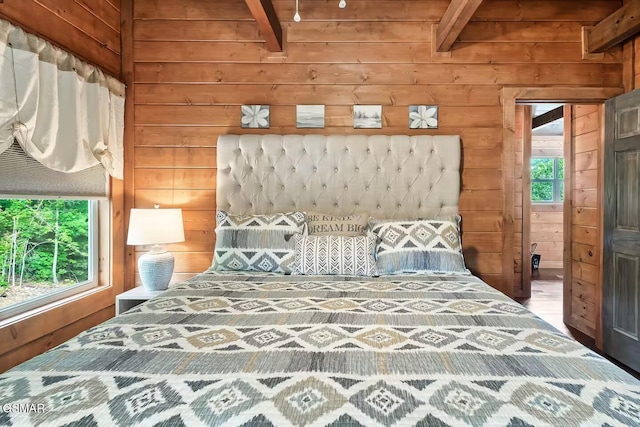 4427 Stackstone Rd, Sevierville, TN 37862 - bedroom featuring wood walls, multiple windows, and wooden ceiling with exposed beams