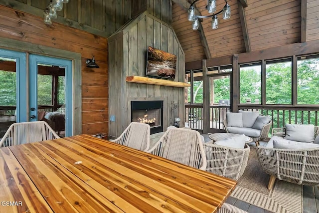 4427 Stackstone Rd, Sevierville, TN 37862 - living room with french doors, a fireplace, wood walls, high vaulted ceiling, and wood ceiling with exposed beams