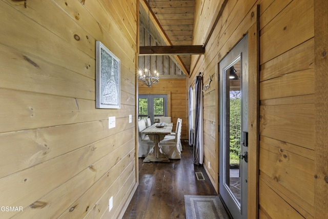 4427 Stackstone Rd, Sevierville, TN 37862 - hallway with wood walls, dark wood-style floors, and a chandelier