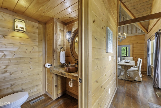 4427 Stackstone Rd, Sevierville, TN 37862 - half bathroom featuring wooden walls, wooden ceiling, hardwood / wood-style floors, a sink, and toilet