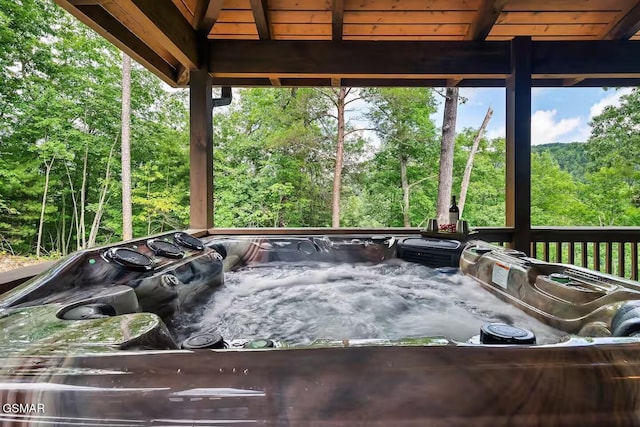 4427 Stackstone Rd, Sevierville, TN 37862 - wooden deck with a hot tub and a view of trees