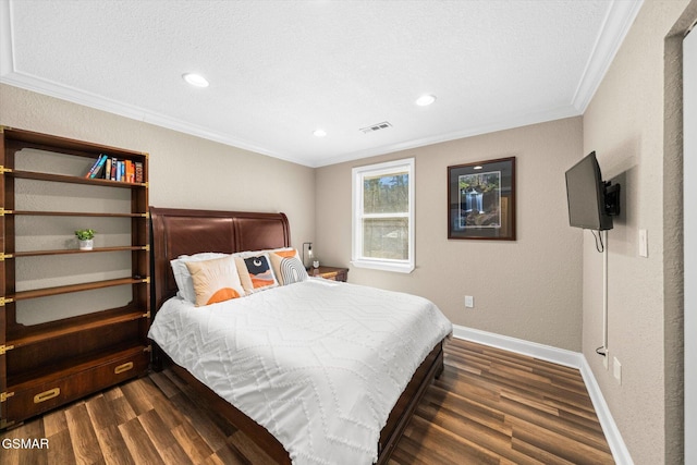 bedroom featuring dark wood finished floors, visible vents, baseboards, and ornamental molding