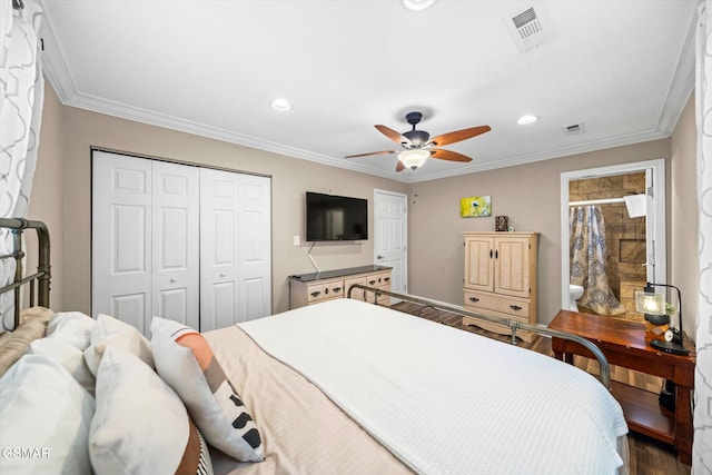 bedroom featuring visible vents, a closet, dark wood-style flooring, and crown molding