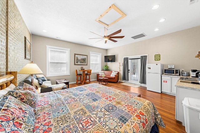 bedroom with a ceiling fan, wood finished floors, visible vents, recessed lighting, and freestanding refrigerator