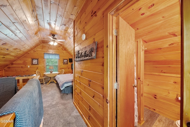 bedroom with wood walls, vaulted ceiling, and wooden ceiling
