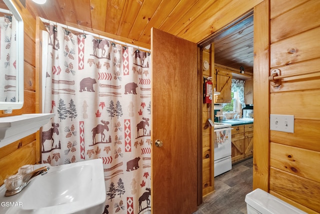 bathroom with wooden ceiling, a sink, wood finished floors, and a shower with shower curtain