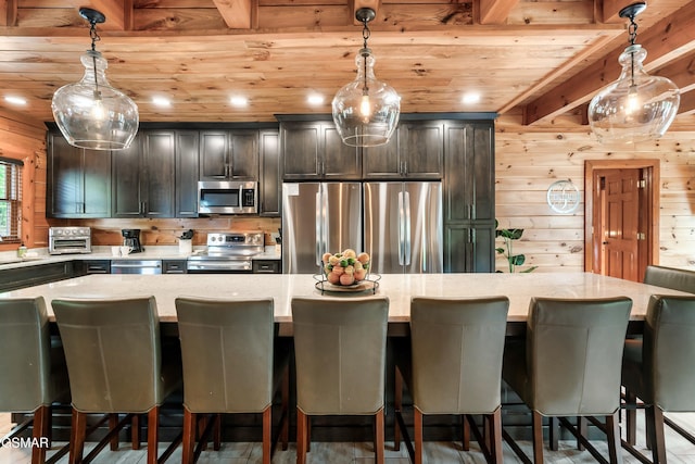 kitchen featuring a breakfast bar area, a kitchen island, and stainless steel appliances