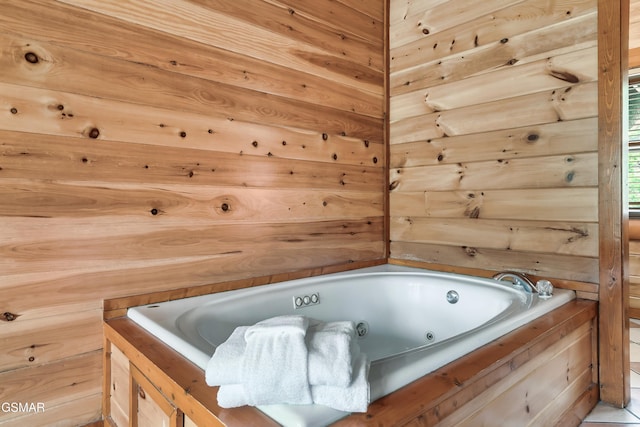 bathroom with wooden walls and a bath