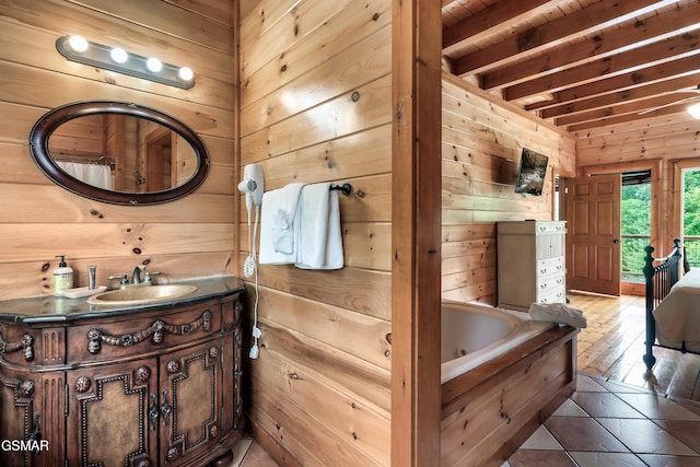 bathroom with tile patterned floors, vanity, wooden ceiling, beamed ceiling, and a tub