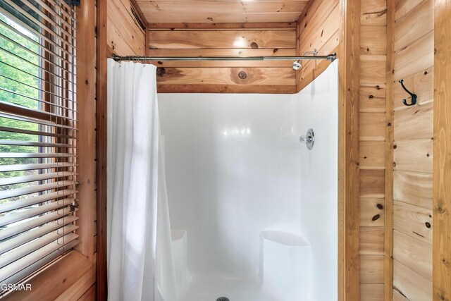 bathroom featuring wooden ceiling, curtained shower, and a healthy amount of sunlight