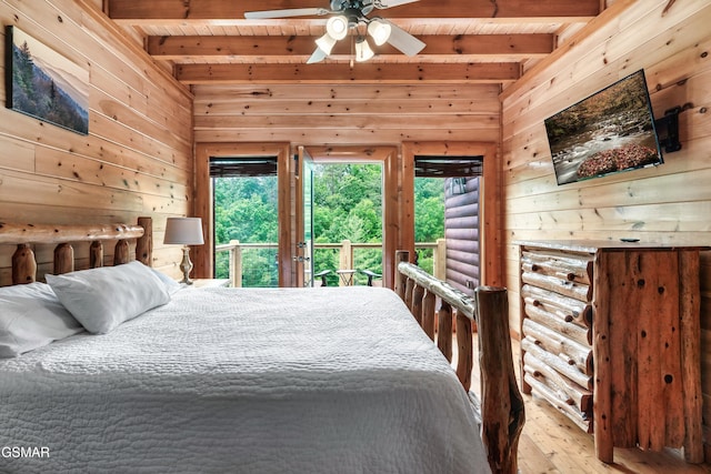 bedroom with wood walls, beam ceiling, wood ceiling, and rustic walls