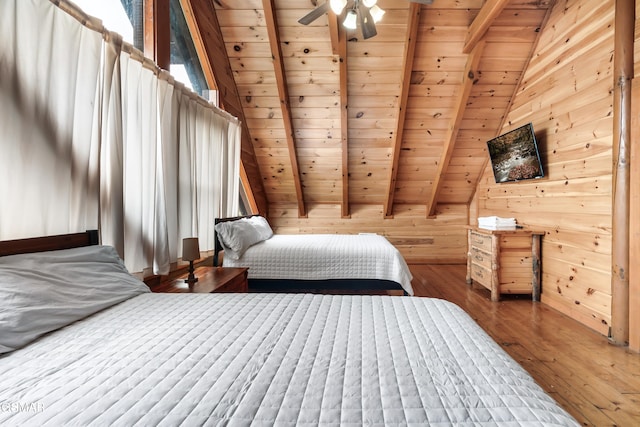 bedroom featuring hardwood / wood-style floors, wood walls, lofted ceiling with beams, ceiling fan, and wood ceiling