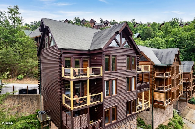 rear view of property with a balcony and cooling unit