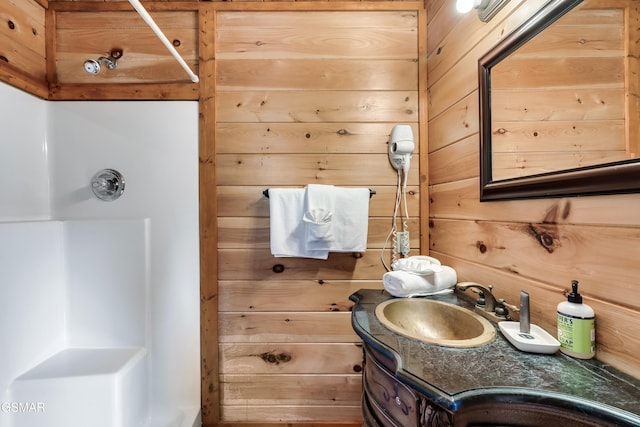 bathroom featuring vanity and wood walls