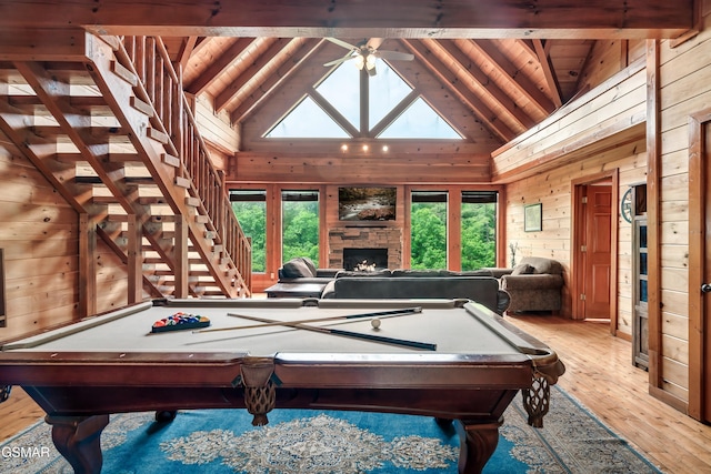 playroom with a fireplace, wooden walls, plenty of natural light, and billiards