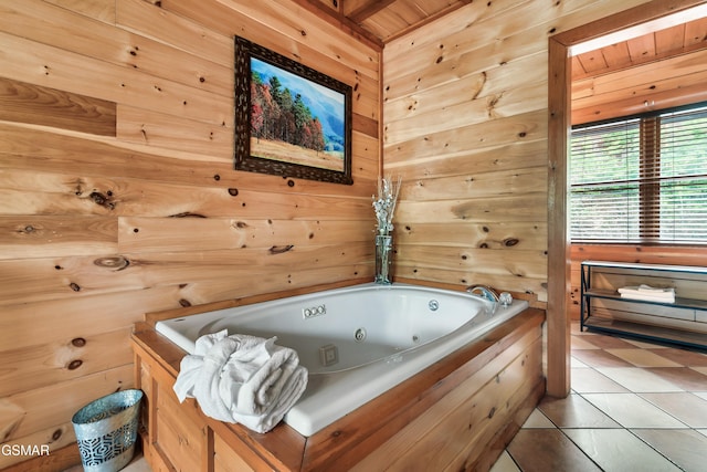 bathroom featuring tile patterned flooring, a bath, wooden walls, and wooden ceiling