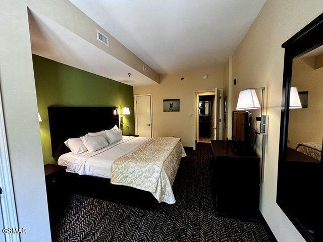 carpeted bedroom with visible vents