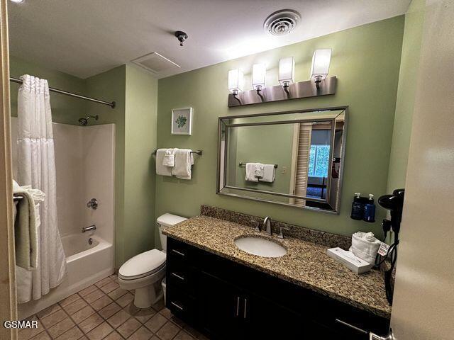 full bath with visible vents, toilet, tile patterned floors, shower / bath combination with curtain, and vanity