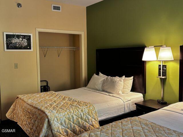 bedroom featuring a closet and visible vents