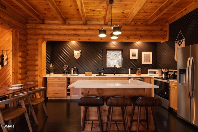 1317 Old Knoxville Hwy, Sevierville, TN 37876 - kitchen with stainless steel appliances, light countertops, log walls, dark wood-style flooring, and wooden ceiling with exposed beams