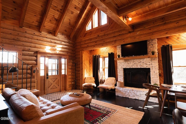 1317 Old Knoxville Hwy, Sevierville, TN 37876 - living room with wood ceiling with exposed beams, a high ceiling, wood finished floors, rustic walls, and a stone fireplace