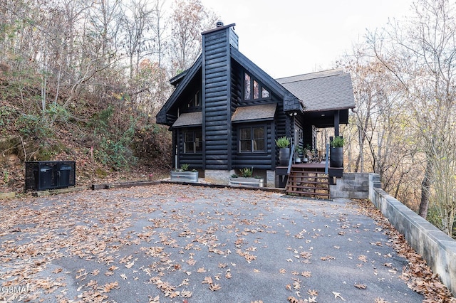 1317 Old Knoxville Hwy, Sevierville, TN 37876 - view of front of property featuring a chimney, a shingled roof, and log siding