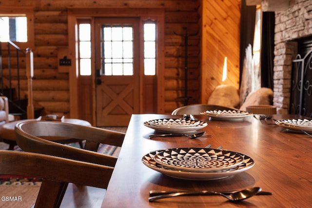 1317 Old Knoxville Hwy, Sevierville, TN 37876 - dining space featuring log walls, stairs, healthy amount of natural light, wood finished floors, and a fireplace